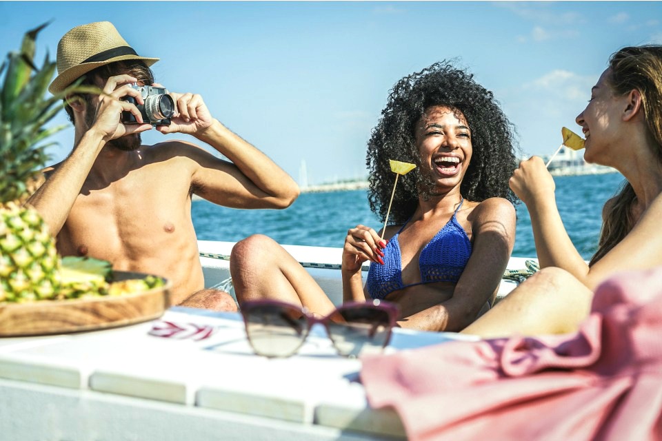 guy and two women on boat eating healthy